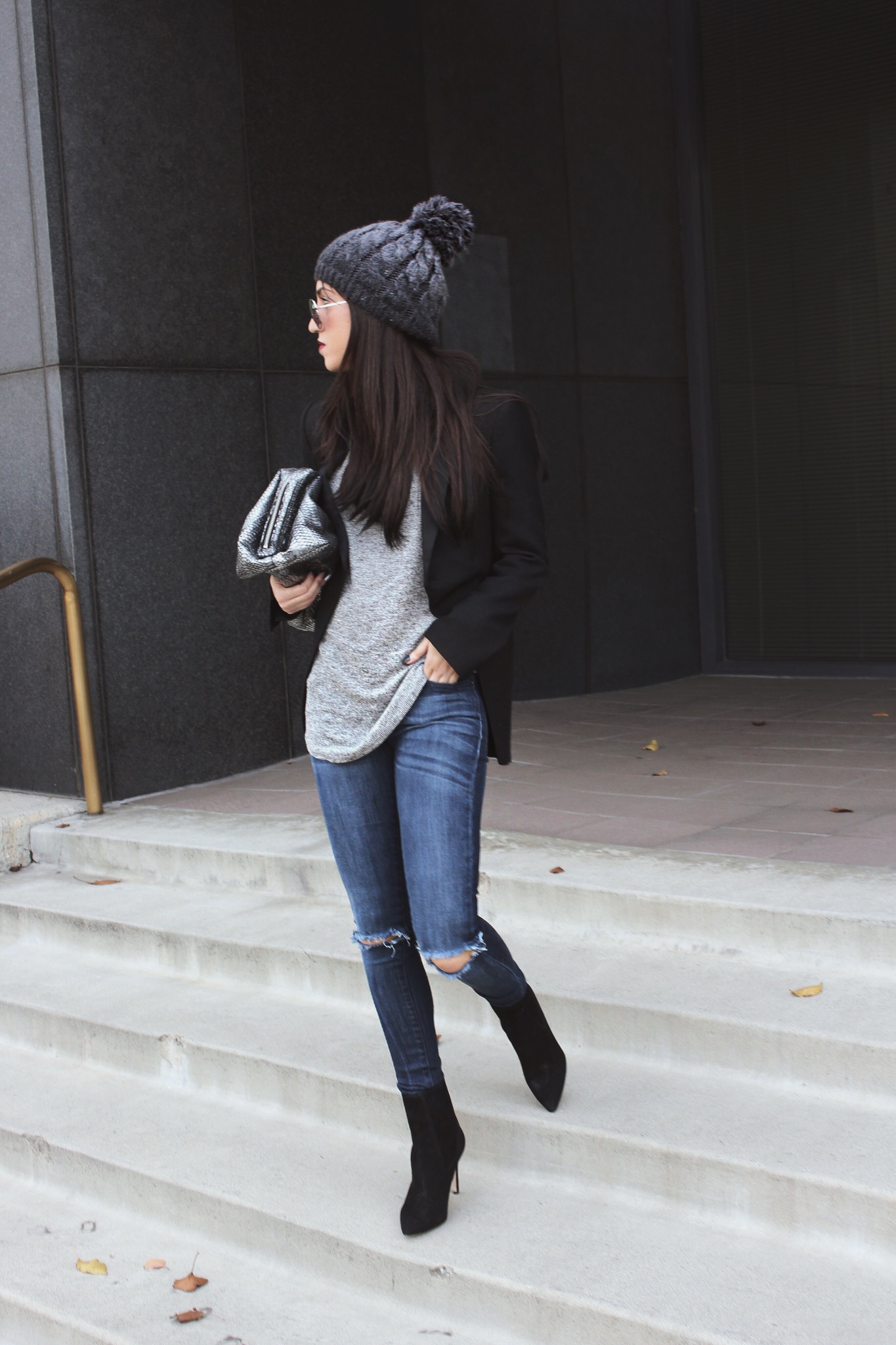 LA blogger Tania Sarin with knit beanie and metallic clutch