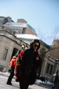 LA Blogger Tania Sarin in New York during NYFW in red fur coat and chanel crossbody