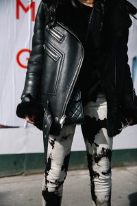 LA Blogger Tania Sarin in New York during NYFW in leather jacket, chanel crossbody, and tiedye pants