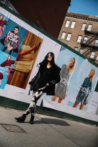 LA Blogger Tania Sarin in New York during NYFW in leather jacket, chanel crossbody, and tiedye pants