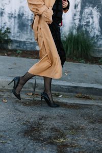 LA Blogger Tania Sarin in trench coat, loewe bag, and red lip