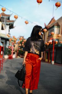 LA Blogger Tania Sarin in China town wearing red pant and vintage tee shooting editorial style