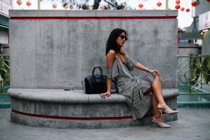 LA Blogger Tania Sarin in chinatown showing wedding season fashion with alexander wang slip silk dress, prada heels, and givenchy bag